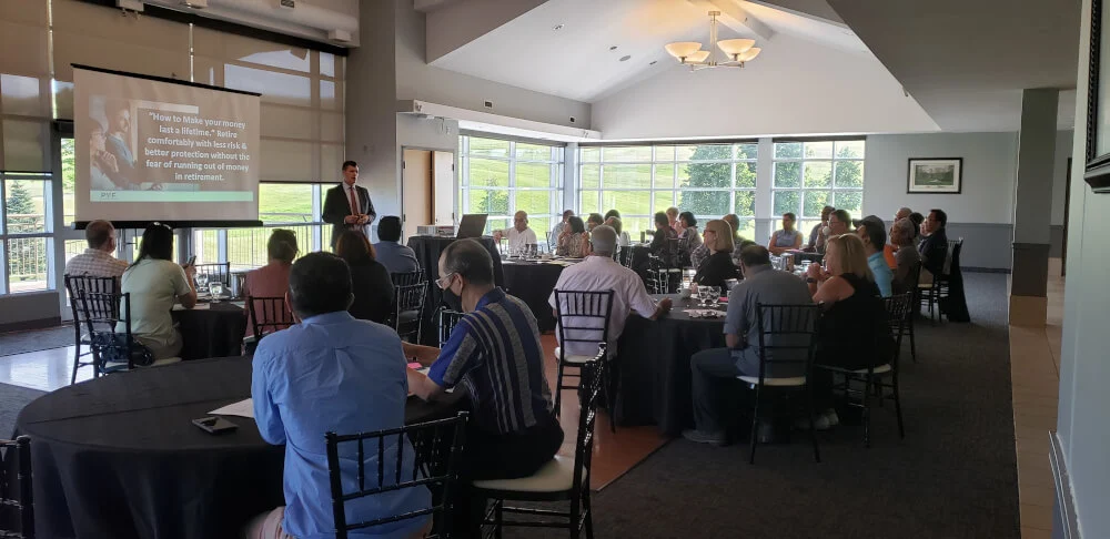 A financial advisor presenting to an audience at a runseminars.com seminar