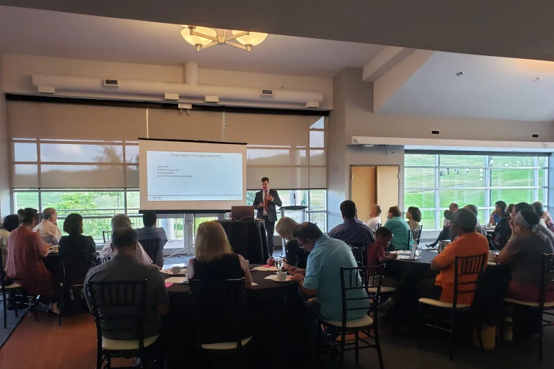 Attendees at a seminar run for a financial advisor client